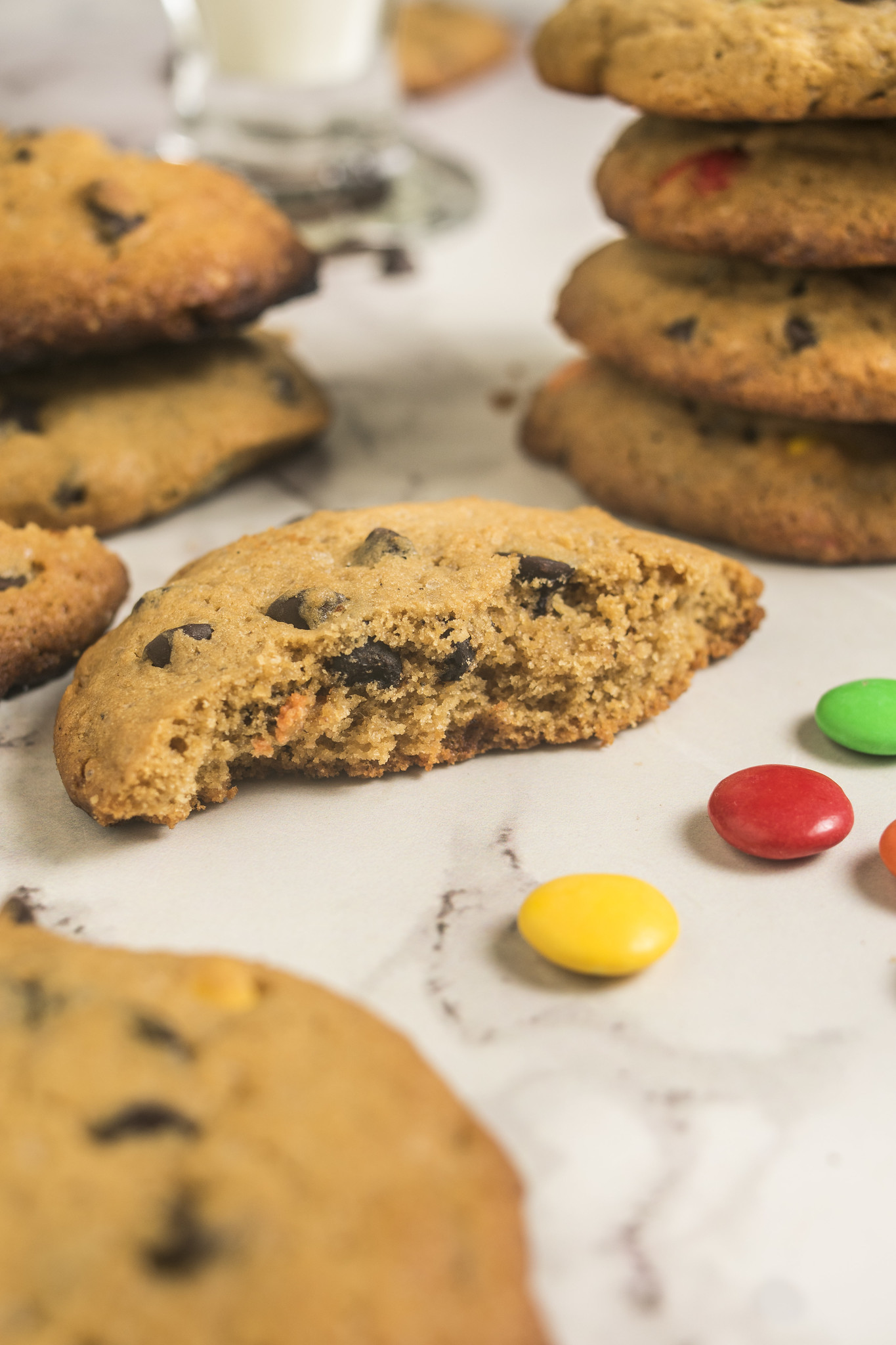 Browned butter chocolate chip cookie broken open to show its soft centre and chocolate pieces.